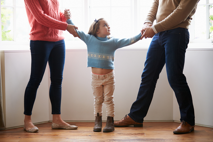 Parents in conflict pulling child in different directions representing family disputes