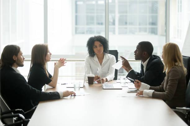 Business dispute conflict before civil mediation Texas — tense meeting room disagreement